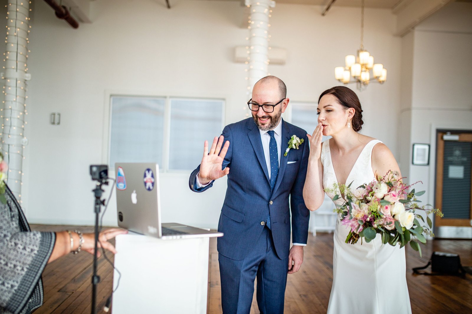 wedding couple looking at computer screen