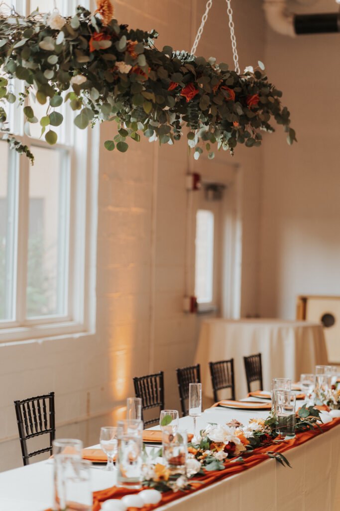 hanging floral and foliage installation at a fall wedding