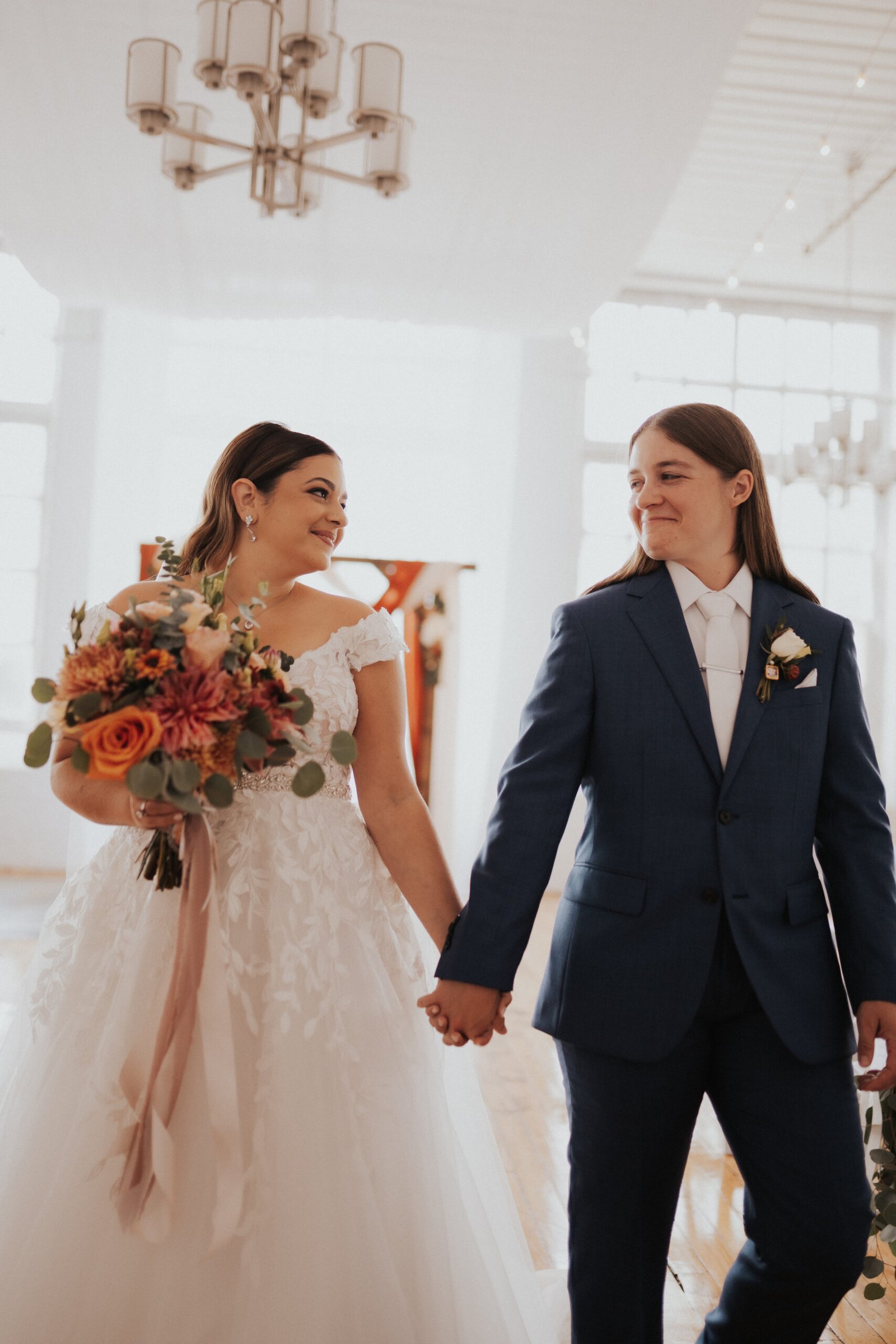 Wedding couple, bride and bride, orange wedding flowers